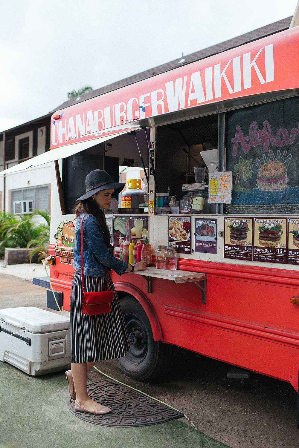 woman standing in front of Ohana burger Waikiki food truck