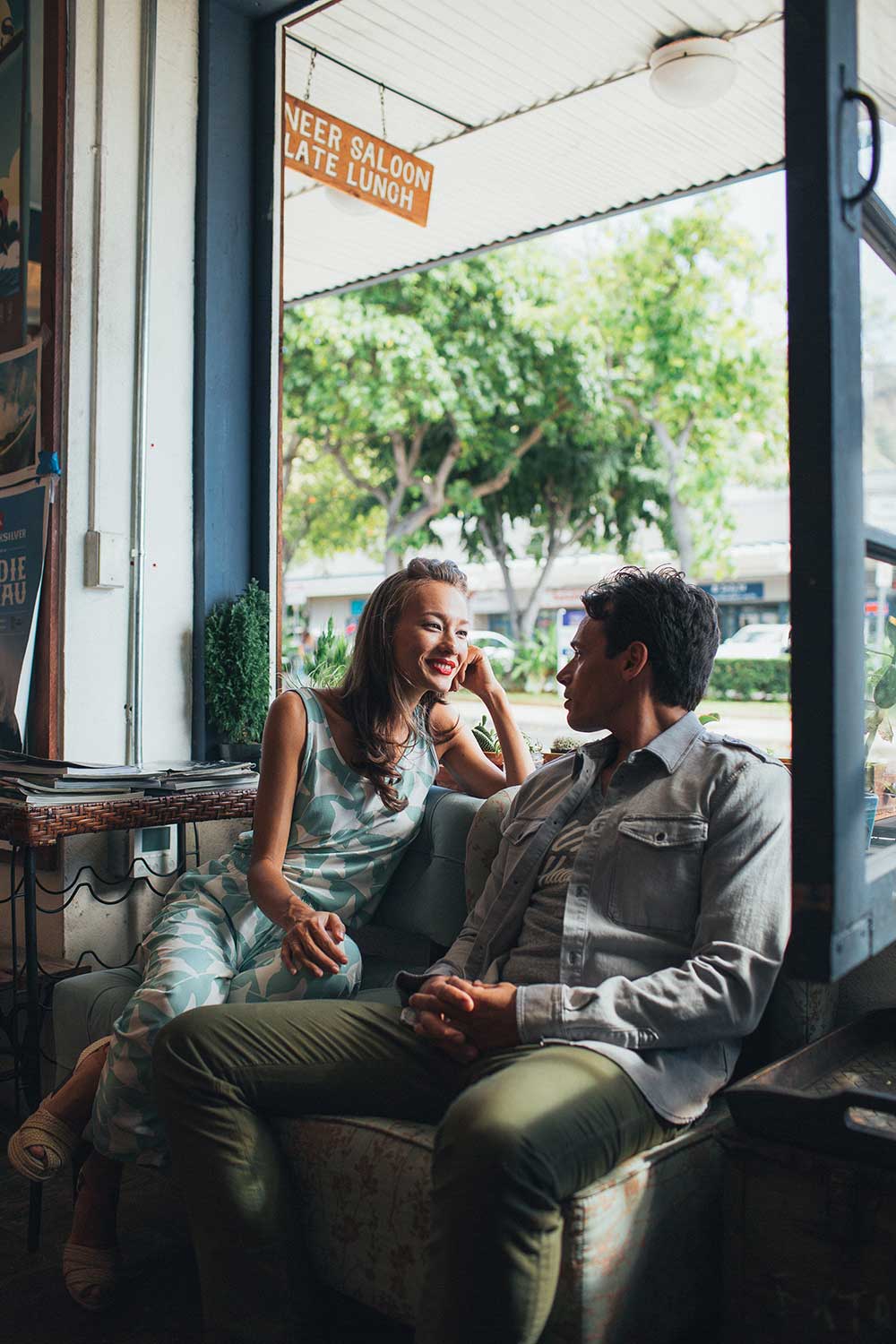 woman and man sitting on couch in restaurant talking