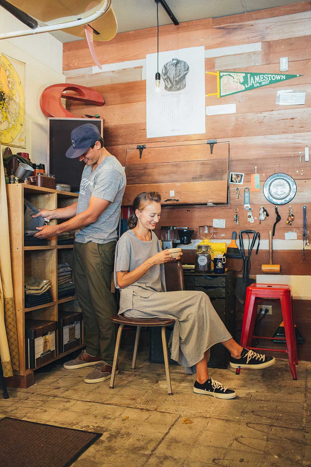 man and woman enjoying coffee inside wood paneled coffee shop