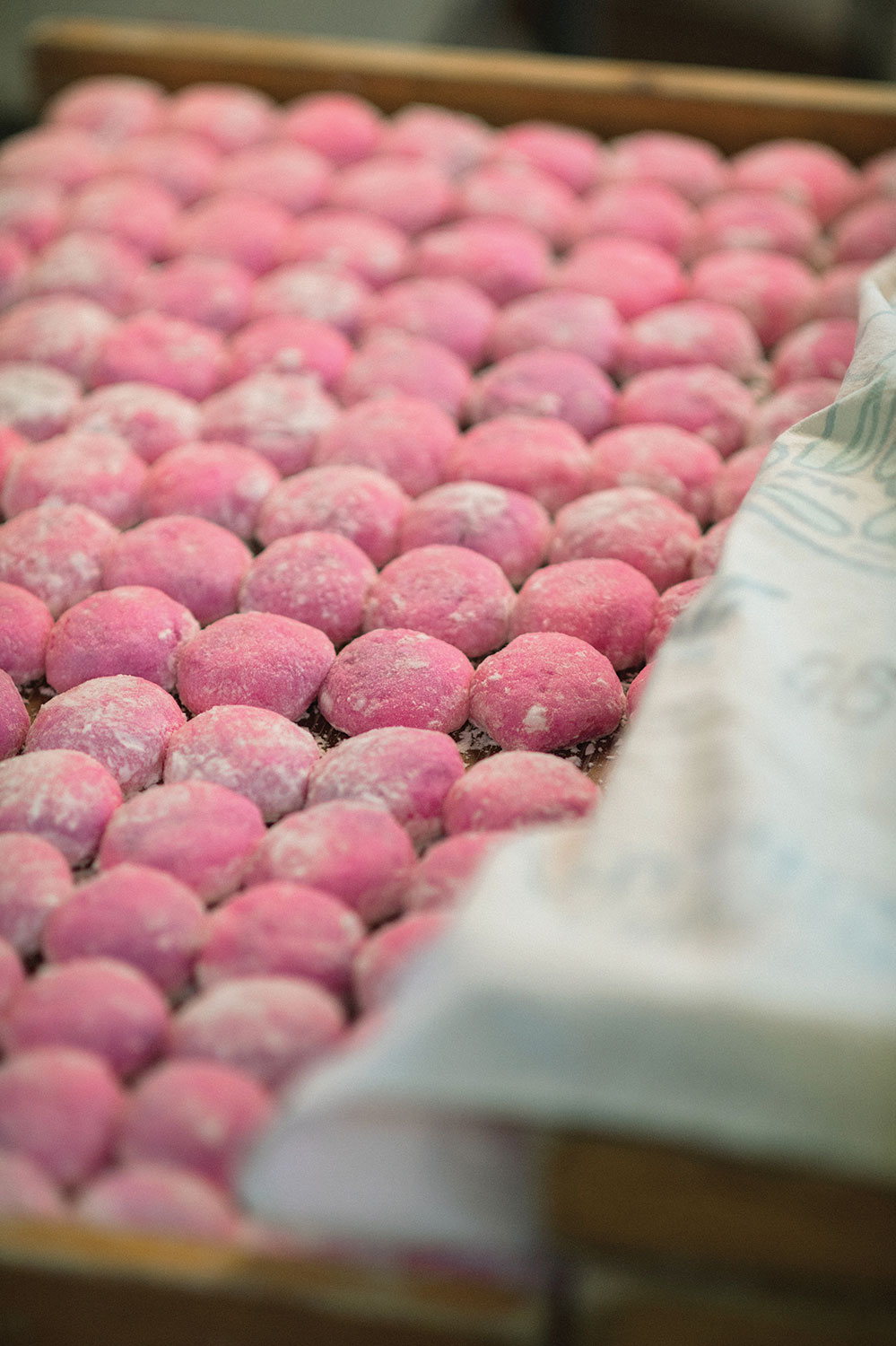 Pink colored mochi in rows.